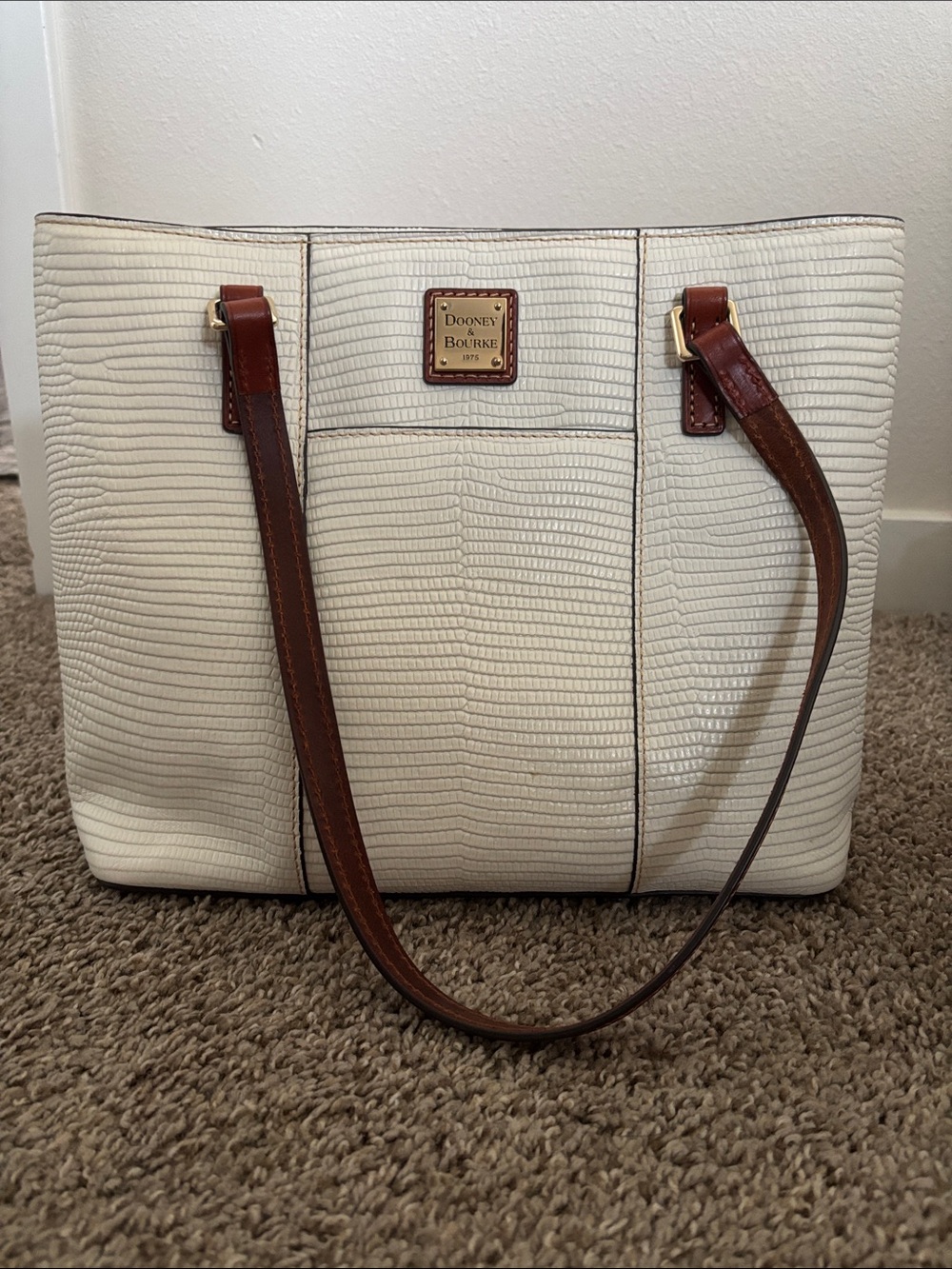 Dooney & Bourke Cream Tote with Brown Leather Straps and Gold Plaque